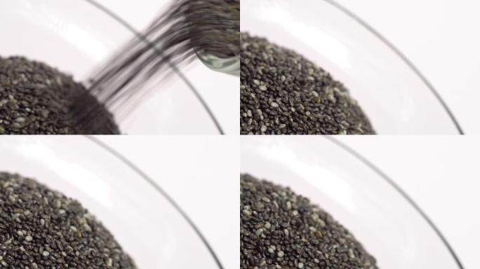 Pouring small chia seeds in glass ball in旋转