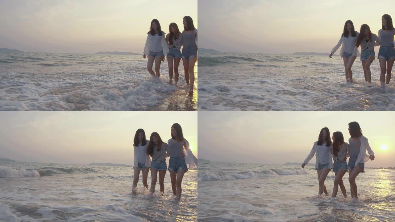 微笑快乐的亚洲朋友一群年轻女性一起在海滩上海边散步暑假日落剪影黄昏假期旅游享受生活周末活动人们的生活