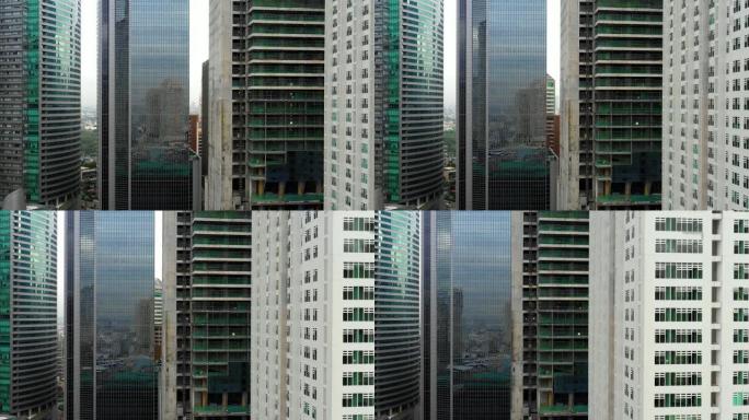 马尼拉在菲律宾首都的建筑。窗户上有城市倒影的现代建筑 -- 空中和近距离