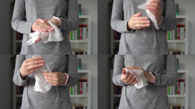特写中段的年轻白人妇女用白色酒精组织擦拭手清洁消毒从病毒和细菌在家里或办公室前视图