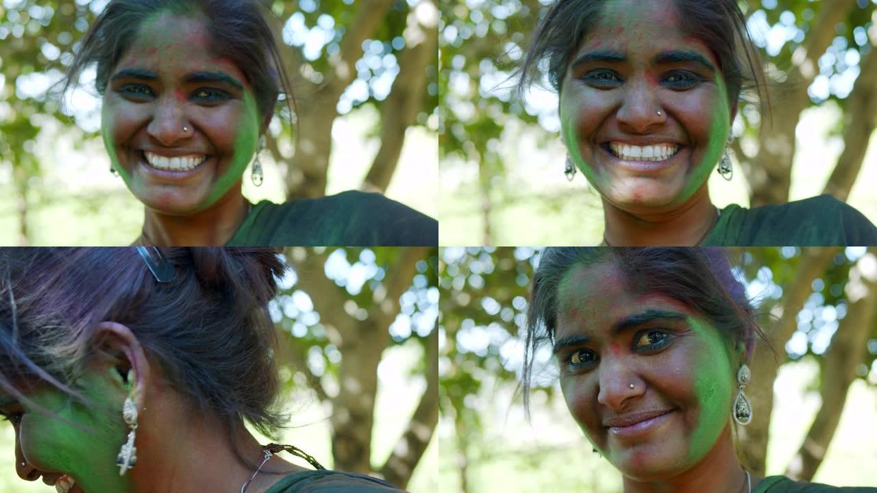 印度妇女特写脸部涂满明亮的胡里节颜色