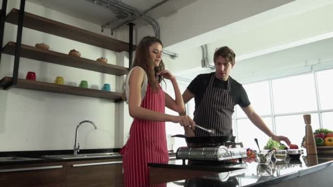 可爱的夫妇在现代厨房做饭