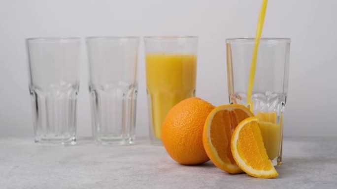 美味健康的冷却橙汁倒入玻璃杯