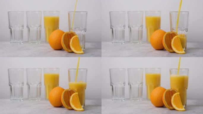 美味健康的冷却橙汁倒入玻璃杯