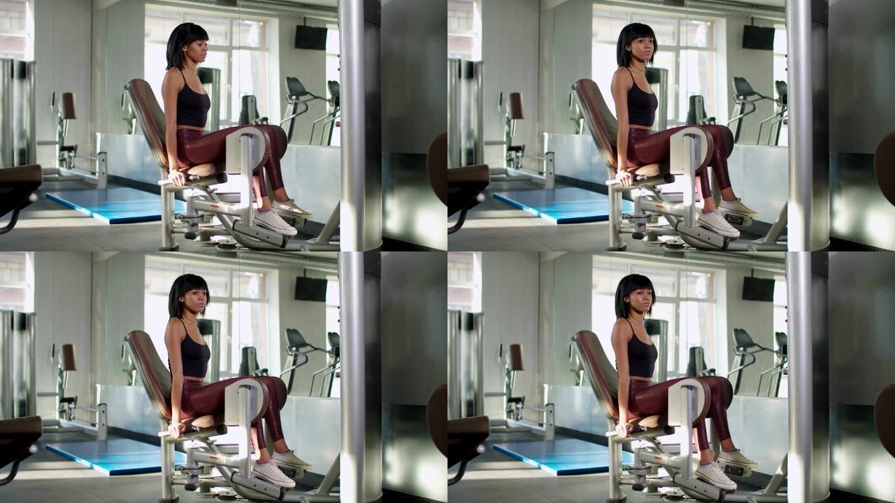 女性在大腿内侧机器上进行体重锻炼