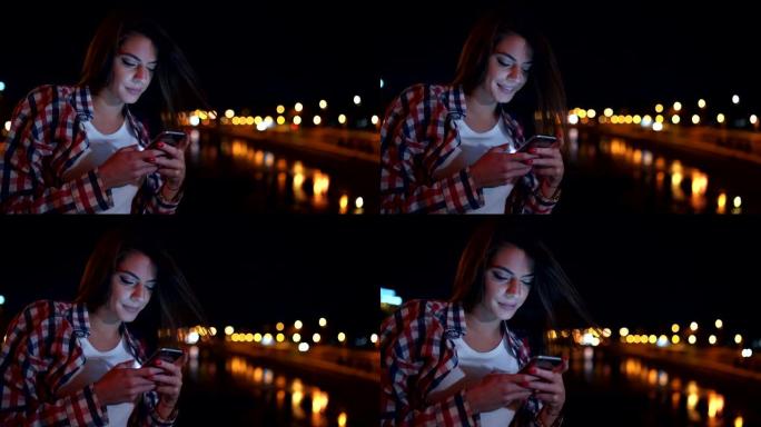 微笑的女人在河边使用手机