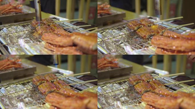 Unagi烤日式淡水鳗鱼放在厨房的炉子上
