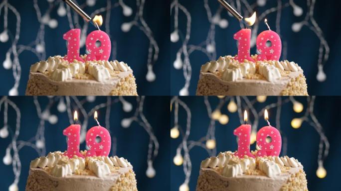 蓝色背景上有19号粉色蜡烛的生日蛋糕。蜡烛着火了。慢动作和特写视图