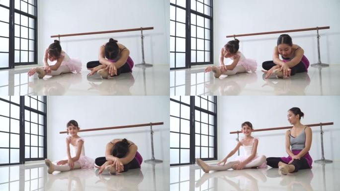 芭蕾舞女演员老师和学生坐着伸展身体和腿