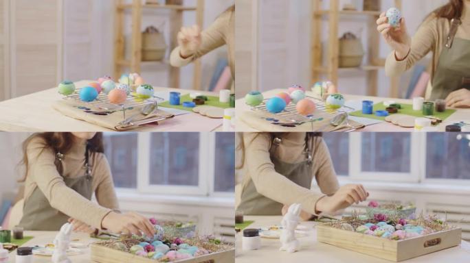 女人将手绘复活节彩蛋放入木托盘