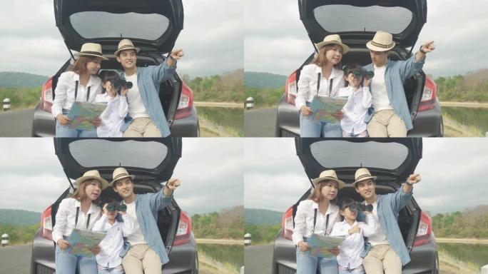 亚洲家庭的肖像坐在车里，父亲指着风景，母亲拿着地图，女儿在度假时用双筒望远镜看着美丽的风景。幸福的家
