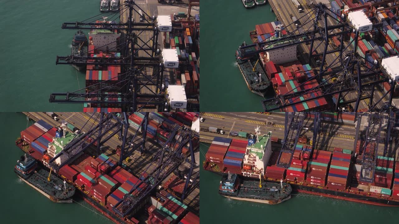 香港v18飞机低空飞过正在船厂码头装载的大型货船。