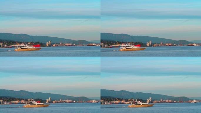 机动游艇在北温哥华工业区和大型商船前穿越温哥华港。