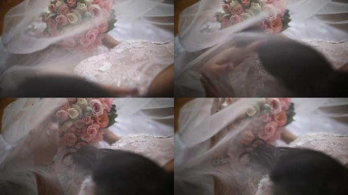 新娘拿着婚礼花束，坐着摸着头发