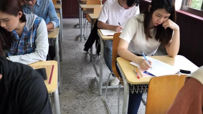 亚洲学生参加考试一排教室作答