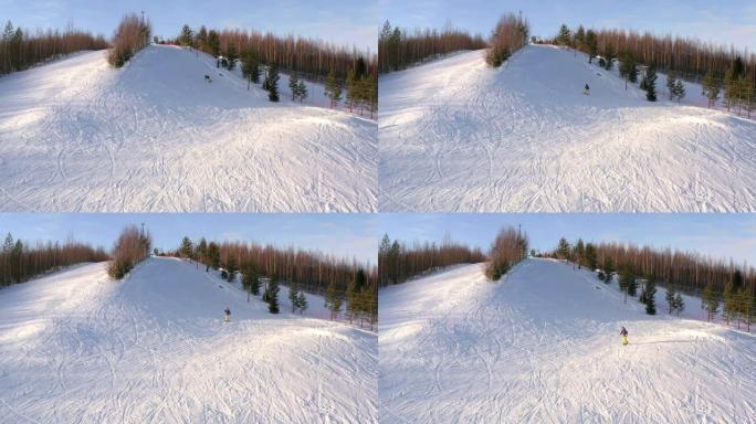 滑雪者在冬天骑在山腰上，俯视图