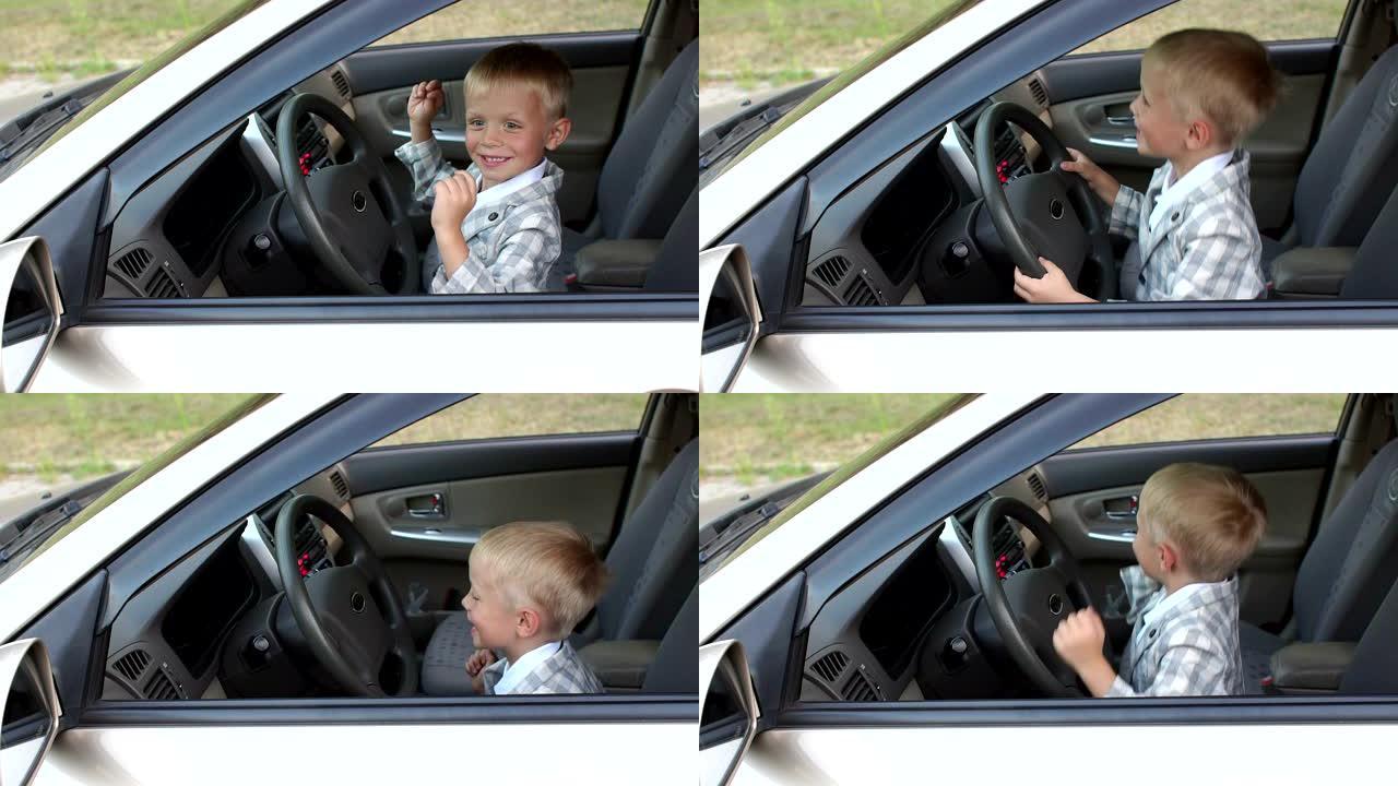 一个小男孩坐在汽车的方向盘后面，他使音乐更大声并跳舞。