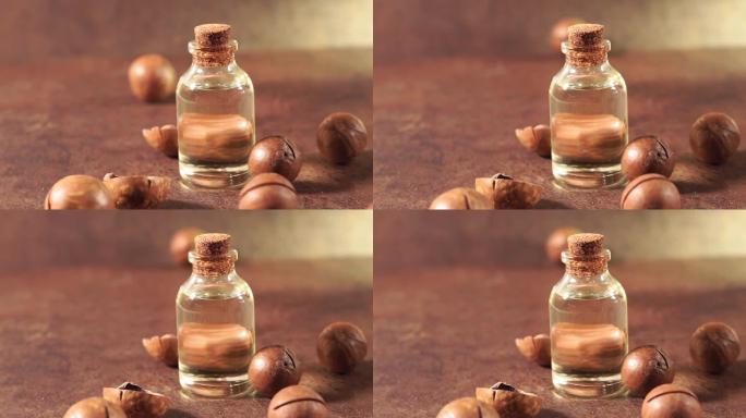 澳洲坚果油。澳洲坚果，杏仁，核桃，松子的化妆品和治疗油在棕色背景，特写
