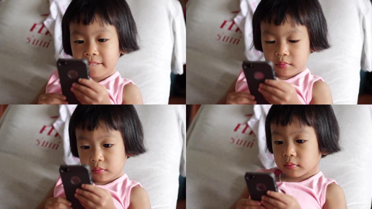 亚洲小女孩在家使用智能手机