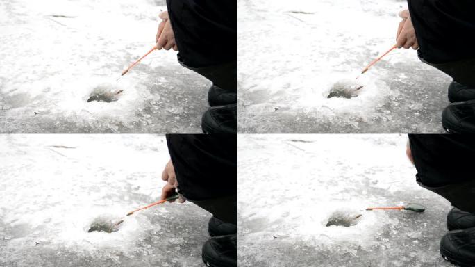 渔夫在冬季湖上的冰洞里钓鱼
