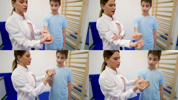 物理治疗师和她的年轻病人一起做治疗性手臂练习。