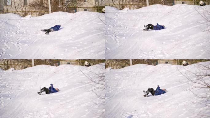 快乐的男孩快乐地躺在雪地上。