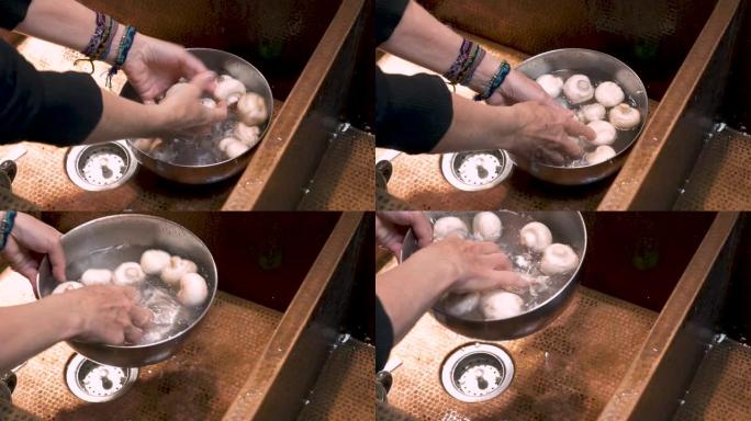 一个人用淡水在碗里冲洗白蘑菇的特写镜头