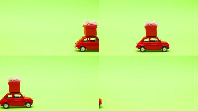绿色屏幕上的小红色老式汽车在屋顶上驾驶红色礼物-停止运动