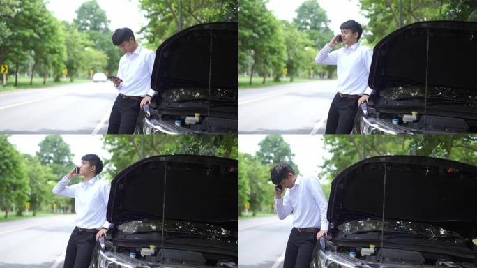 年轻人站在他的破车前，正在打电话学习汽车修理工。