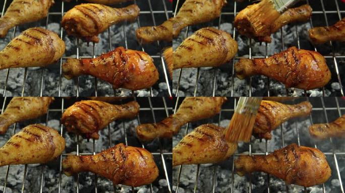 烧烤烤架上的烤鸡腿。烹饪过程。腌料润滑脂