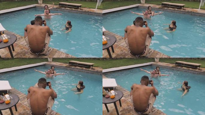 男子在游泳池中拍摄或拍摄年轻女子的照片