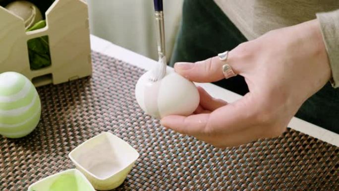 白人妇女在家画复活节彩蛋的特写镜头。4K