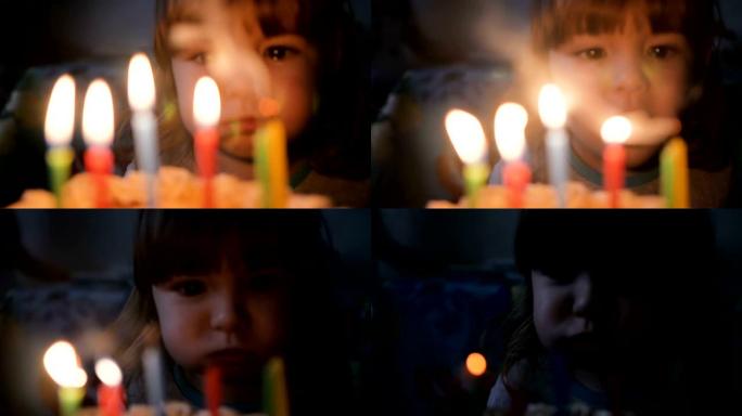 小男孩在派对上吹灭生日蛋糕上的蜡烛。特写。慢动作。