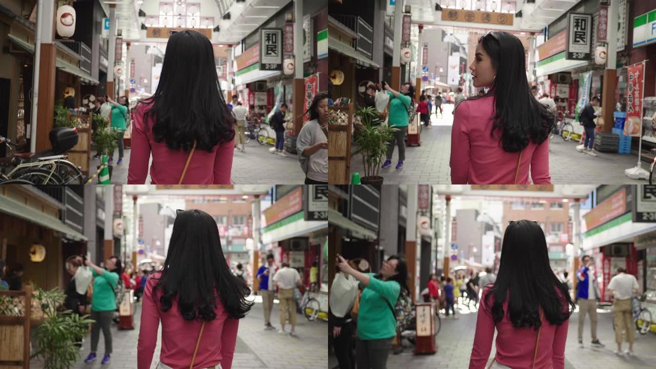 在日本的步行街上行走的亚洲妇女