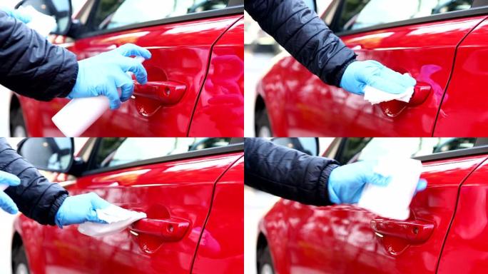 人喷消毒液用湿巾擦拭汽车