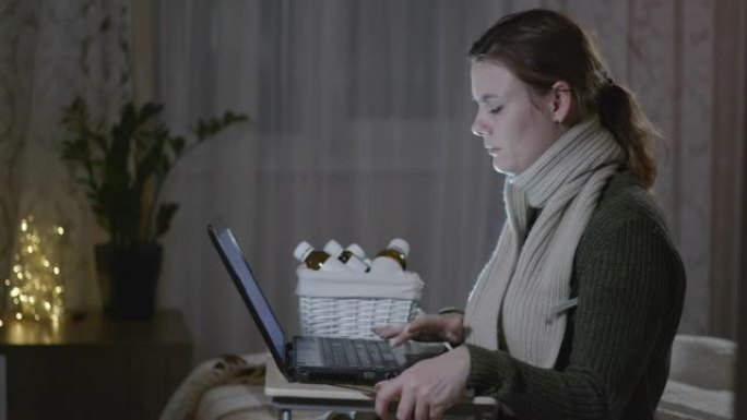 治疗患病的女孩，患有病毒性疾病或流感的年轻女子用温度计测量温度坐在笔记本电脑上，并在线订购药物