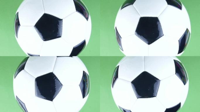足球在绿色背景上旋转。足球。冠军。欧洲。世界。奥运会。运动。