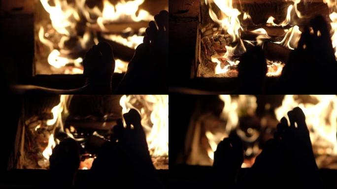 这对夫妇在温暖的炉火旁放松，温暖着他们裸露的双腿。