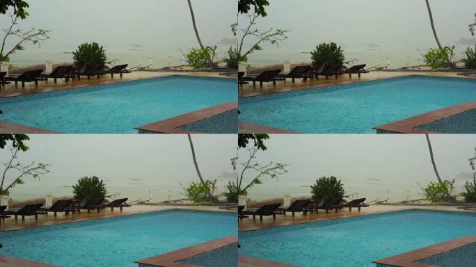 热带夏季雨水落在海上游泳池上