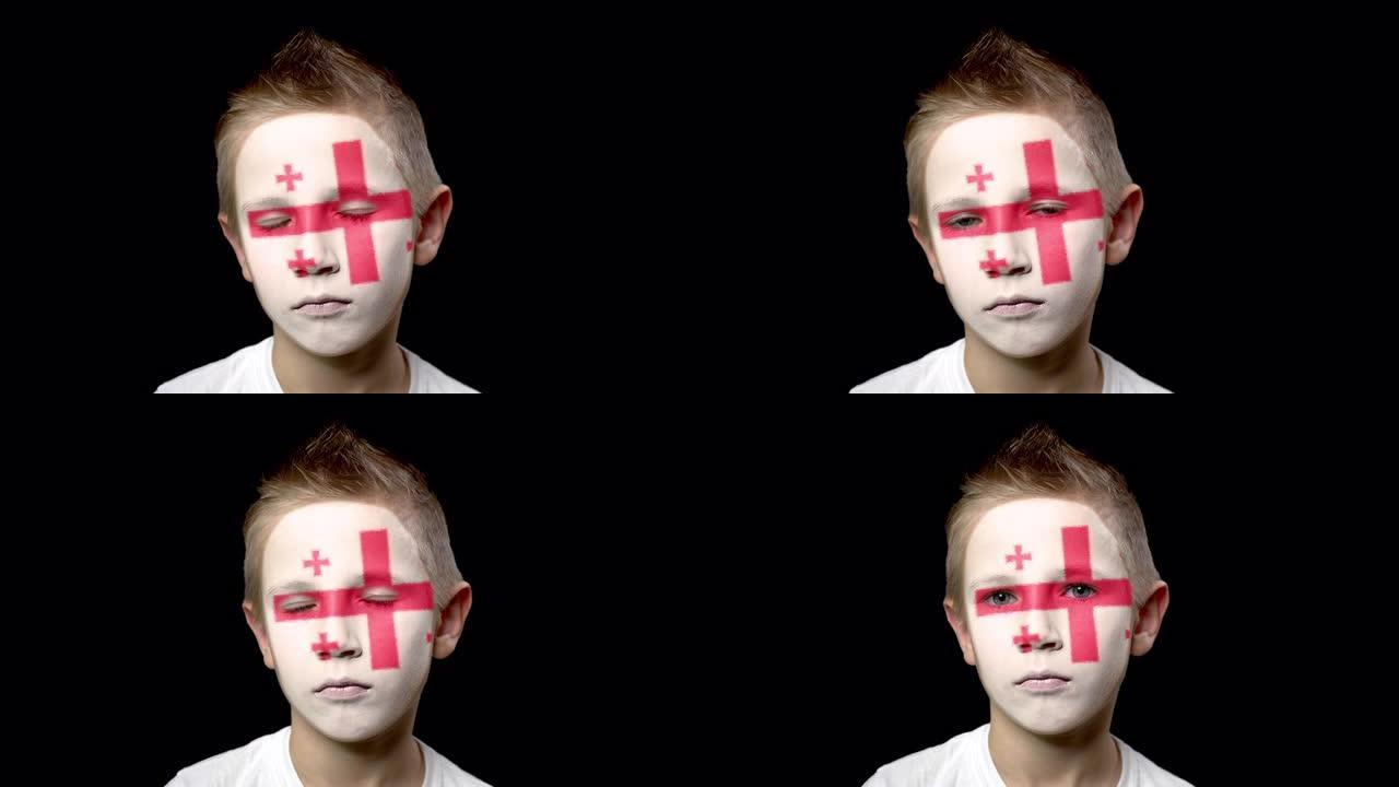 乔治亚州足球队的伤心球迷。脸上涂着民族色彩的孩子。