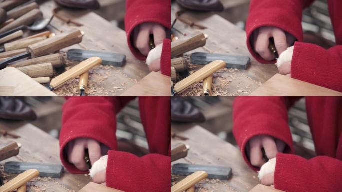 这家伙在磨石上手工削凿木头的凿子。特写