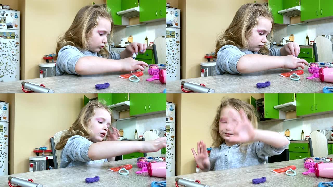 小女孩用儿童指甲油涂指甲。