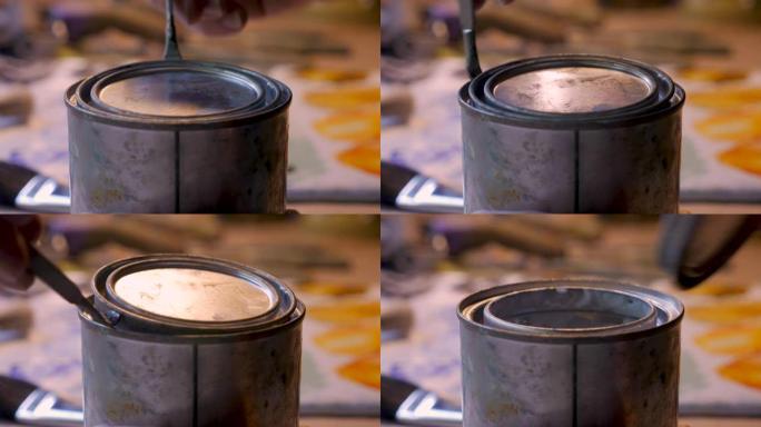 用油漆开罐器打开一个小罐
