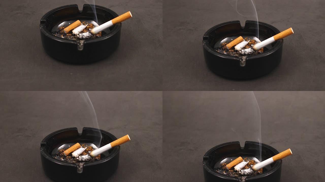 用烟头在烟灰缸中燃烧香烟