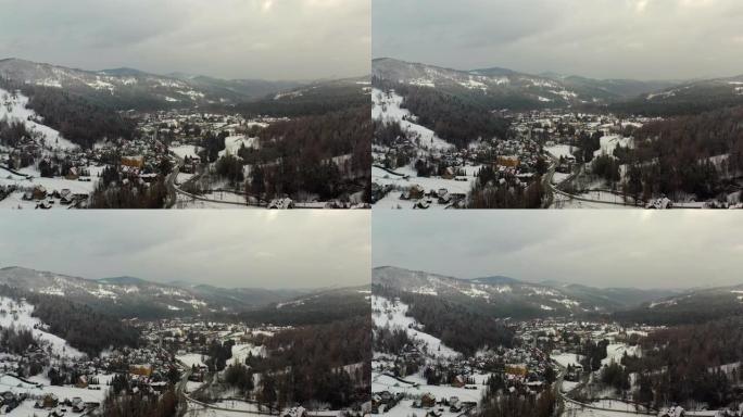 覆盖着雪的森林鸟瞰图。山中村庄的鸟瞰图
