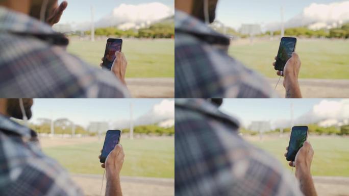 一名男子在公园里和他的朋友用智能手机在网上聊天的肩膀上拍了视频