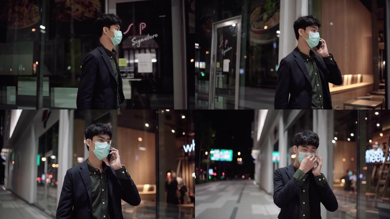 在城市街道之夜，一名戴着口罩的男子在路上