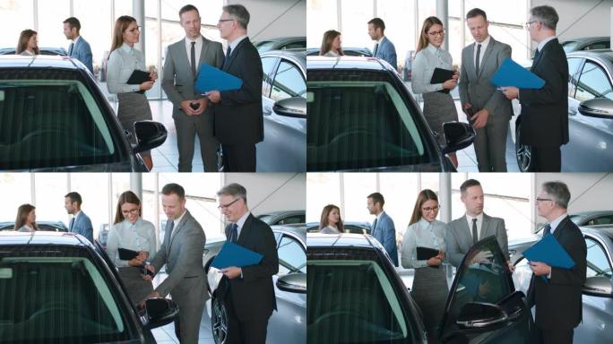 汽车销售人员在汽车经销商处讨论业务策略