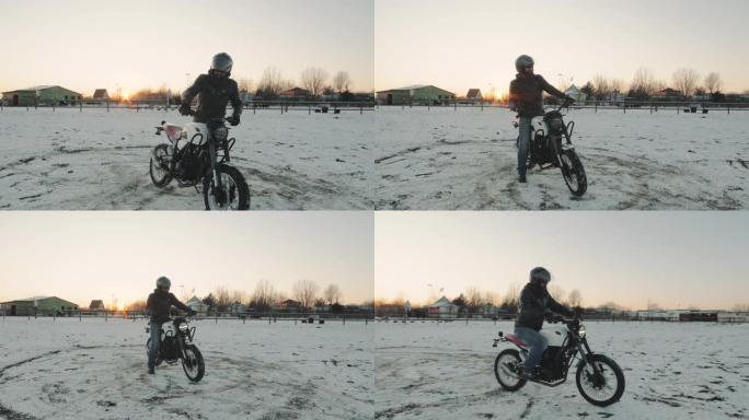 男子摩托车手在日落的冬日骑摩托车。骑自行车的人在雪地里骑自行车，慢动作。