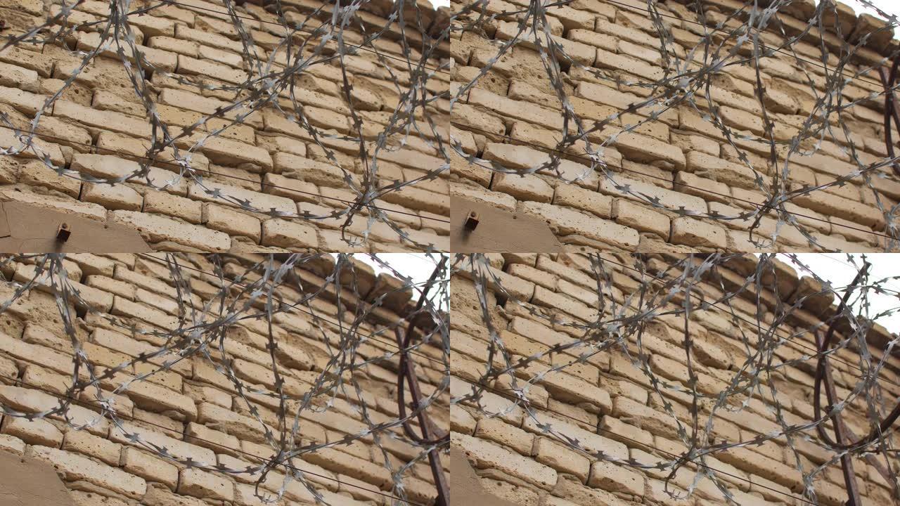 砖墙上的铁丝网防盗铁丝围栏土房子铁丝网